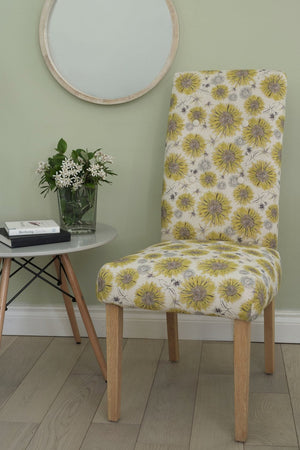 Organic Sunflower and Flora fabric by Seed Home Designs in yellow and beige, large sunflowers upholstered on an armchair