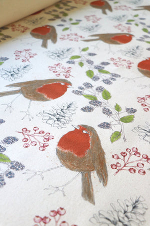 Organic Turn of the Seasons Robin linen by Seed Home Designs in orange and green, draped, showing robins among foliage