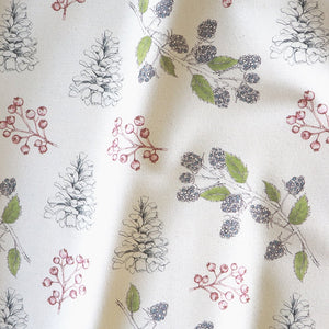 Organic Turn of the Seasons Pinecone and Berry linen by Seed Home Designs in green and red, in soft folds showing