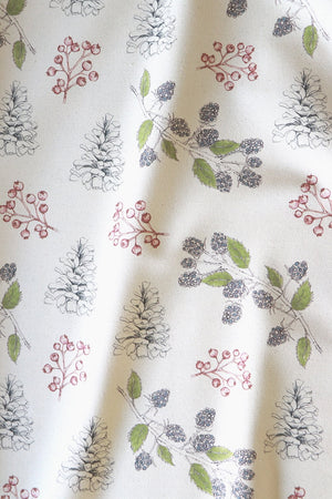 Organic Turn of the Seasons Pinecone and Berry linen by Seed Home Designs in green and red, in soft folds showing