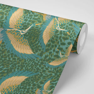 Pachamama wallpaper by Tatie Lou in green, partly unrolled roll showing flying cranes