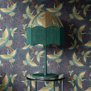 Pachamama wallpaper by Tatie Lou in purple, flying cranes above a sideboard
