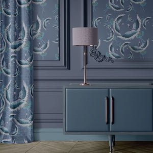Pachamama wallpaper by Tatie Lou in navy, flying cranes above a sideboard