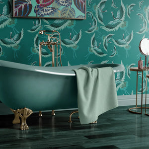 Pachamama wallpaper by Tatie Lou in teal, flying cranes in a bathroom