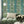 Paradise Party wallpaper by Brand McKenzie in green, a mirrored tropical party scene in a living room