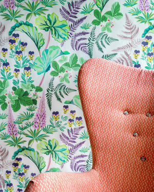 Strawberry Fields wallpaper by Parker and Jules in green, strawberries, ferns and pansies upholstered on an armchair