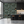 Passementerie wallpaper by Dami and Em Design in dark green, tassels and trimmings in a kitchen