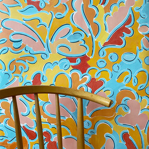 Pauline wallpaper by Claire de Quénetain in pink and blue, a hand-painted floral design in a styled room setting