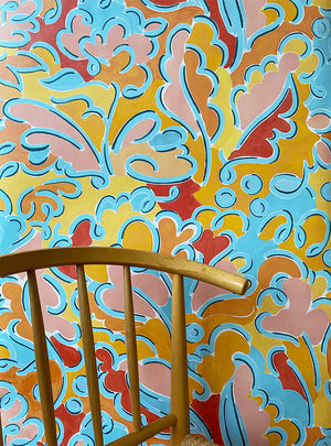 Pauline wallpaper by Claire de Quénetain in pink and blue, a hand-painted floral design in a styled room setting