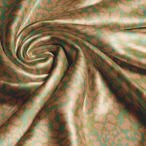 Leopard velvet by Tatie Lou in gold, in soft folds showing a leopard-spot print
