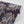 Phoenix wallpaper by Tatie Lou in navy, partly unrolled roll showing swirling phoenix feathers
