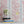 Monkeys and Birds wallpaper by St. Jude's in pink, monkeys and birds on stems above a sideboard