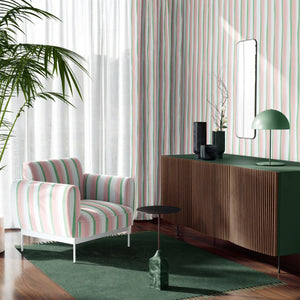 Beside the Seaside wallpaper by Annika Reed in pink and green, seaside stripes behind a sofa in a living room
