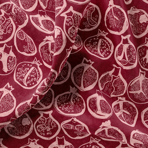 Pomegranate linen by Annika Reed in burgundy, draped close-up of pomegranates
