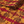 Red River grasscloth by Dami and Em Design in red and orange, roll showing a mirrored marble design