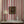 Somerset Stripes wallpaper by Annika Reed in red, painted stripes above a sideboard