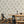 Cardinal wallpaper by XV Interiors in cream, lighthouses and buoys behind a dining table