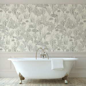 Seaview wallpaper by XV Interiors in cream, fish among seaweed on a bathroom wall