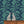 Rubber Plant wallpaper by Annika Reed in navy and green, rubber plant leaves above a sideboard