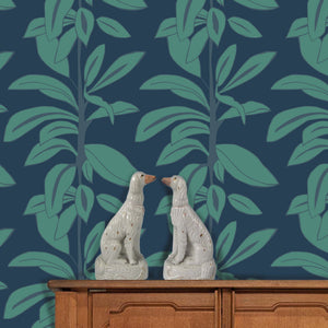 Rubber Plant wallpaper by Annika Reed in navy and green, rubber plant leaves above a sideboard