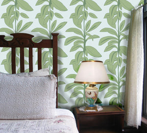 Rubber Plant wallpaper by Annika Reed in sage green, rubber plant leaves in a bedroom