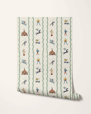 Run Away to the Circus wallpaper by Annika Reed in cream, partly unrolled roll showing circus performers and tents