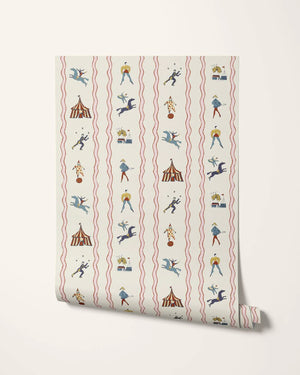 Run Away to the Circus wallpaper by Annika Reed in cream, sample roll showing circus performers and tents
