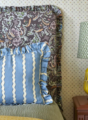 Double Scroll Stripe linen by Parker and Jules in blue, wavy scroll stripes on an upholstered chair
