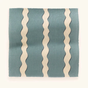 Double Scroll Stripe linen by Parker and Jules in blue, draped close-up of wavy scroll stripes