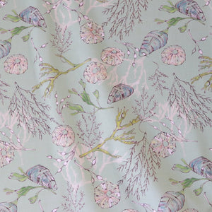 Coastal Cove fabric by Seed Home Designs in green, pattern sample of line-drawn shells and seaweed