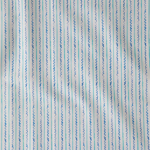 Sea Lines linen by Seed Home Designs in blue and white, draped, showing fine watercolour stripes