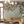Seasons of the Vine wallpaper by Dami and Em Design in green, grape vines behind a sofa in a living room