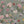 Seasons in Bloom wallpaper by Victoria Sanders in sage green, pattern sample of a meadow of flowers rising from the base