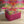 Siesta Key Eco velvet by Liberty James Studio in pink and green upholstered on a fringed footstool