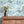 Sky Fair wallpaper by Brand McKenzie in pale blue, a pastel sky fair above a sideboard