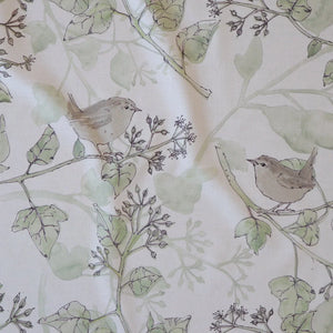 Wrens in the Ivy linen by Seed Home Designs in cream and green, draped, showing wrens among ivy