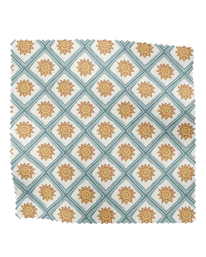 Solstice Sun linen by Annika Reed in blue and orange, flat sample of suns in a lattice