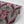 Soltar wallpaper by Tatie Lou in pink, partly unrolled roll showing a Deco arch pattern