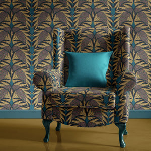 Plume wallpaper by Tatie Lou in navy and gold, Deco plumes upholstered on an armchair
