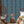 Passion Flower wallpaper by Tatie Lou in blue, trailing passion flowers on a living room wall