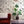 Strong Man wallpaper by Dupenny in black and white, circus strongmen behind a sofa in a living room