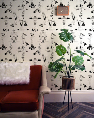 Strong Man wallpaper by Dupenny in black and white, circus strongmen behind a sofa in a living room