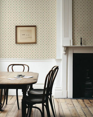 Suits You wallpaper by Annika Reed in cream and red, tiny card suits in a dining area