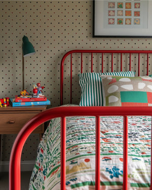 Suits You wallpaper by Annika Reed in cream and red, tiny card suits in a bedroom
