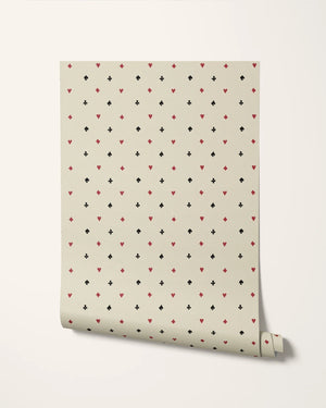 Suits You wallpaper by Annika Reed in cream and red, roll showing tiny card suits