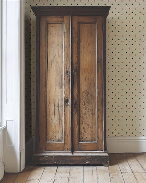 Suits You wallpaper by Annika Reed in cream and red, tiny card suits in a hallway