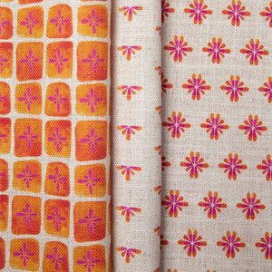 Sun Bloc linen by Bethie Tricks in orange and pink, in soft folds showing a painted grid