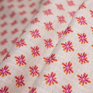 Sunrise linen by Bethie Tricks in pink, draped, showing small star motifs
