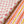 Sunrise linen by Bethie Tricks in pink, in soft folds showing small star motifs