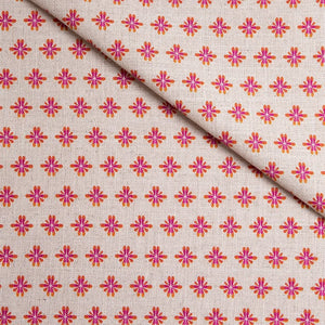 Sunrise linen by Bethie Tricks in pink, draped close-up of small star motifs